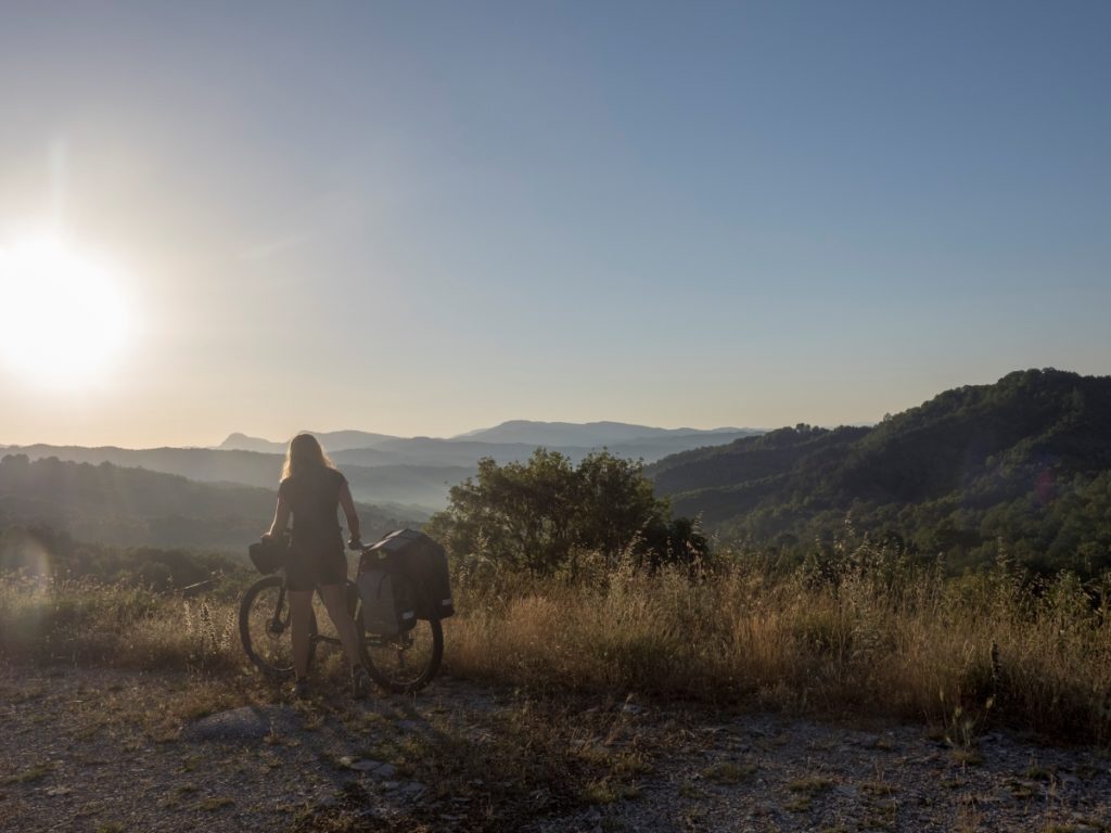 One of the most important strategies for cycling in hot temperatures is to start early in the morning. Here short after sunrise in the Greek Zagori mountains